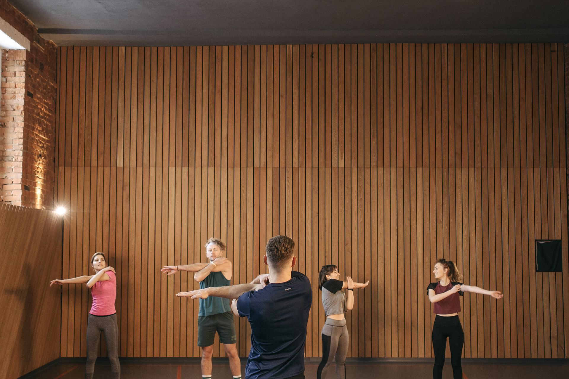 A group fitness class training together in a studio